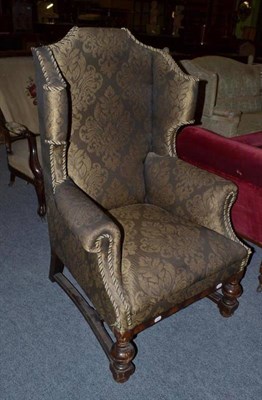 Lot 1072 - A Victorian green upholstered wing back armchair