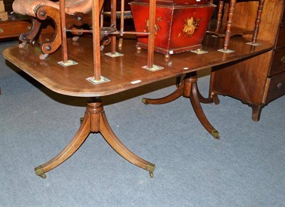 Lot 1116 - A reproduction mahogany twin pedestal extending dining table in George III style