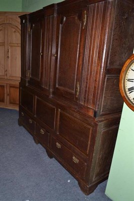 Lot 1145 - An 18th century joined oak press cupboard, northern region, two short and one small drawer,...