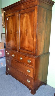 Lot 1164 - A mahogany clothes press in George III style, with two upper shell inlaid doors over a base of...