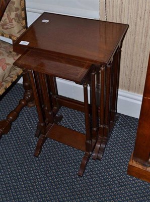 Lot 1184 - A nest of three mahogany satinwood banded occasional tables in the Regency style