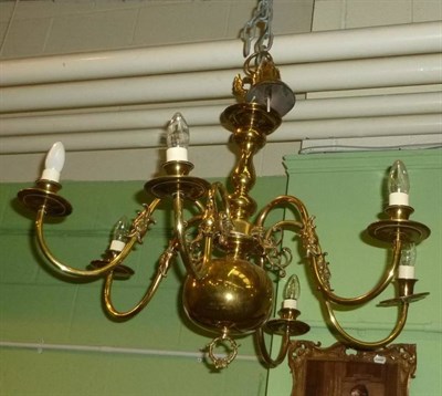 Lot 1220 - A Flemish style six branch brass chandelier