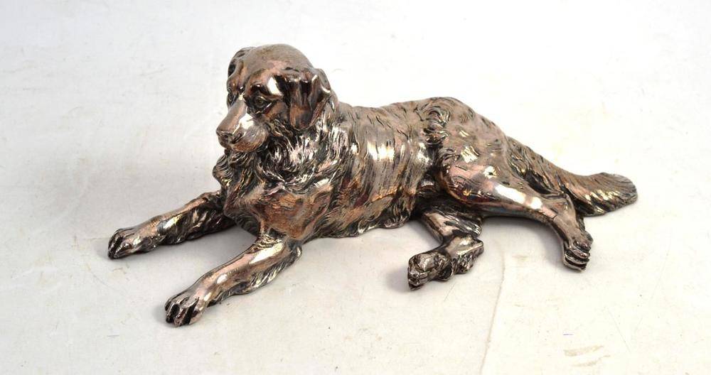 Lot 52 - A Silvered Metal Model of a Recumbent Dog, 26cm long (previously mounted)