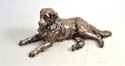 Lot 52 - A Silvered Metal Model of a Recumbent Dog, 26cm long (previously mounted)