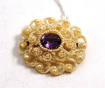 Lot 112 - An Amethyst and Seed Pearl Brooch, the amethyst collet set and surrounded by a scrolling and floral