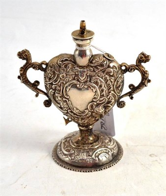 Lot 154 - A Silver Oil Lamp, William Comyns, London, with embossed heart shaped decoration, lion mask...