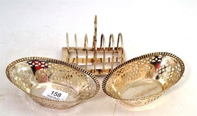 Lot 158 - A Pair of Silver Pierced Oval Sweetmeat Baskets, 15cm wide; and A Silver Toast Rack (3)