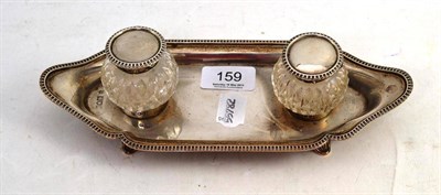 Lot 159 - A Silver Inkstand Dish, London 1904, with a pair of cut glass inkwells with silver mounts, 24cm...