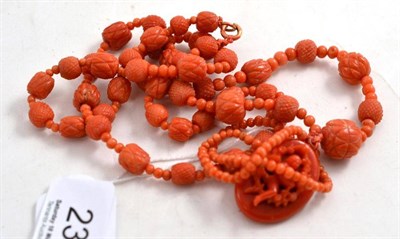 Lot 234 - A Coral Necklace, polished beads interspersed with graduated carved beads, with a carved drop...