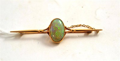 Lot 242 - An Early 20th Century Opal Bar Brooch, the oval cabochon opal in a yellow millegrain setting,...