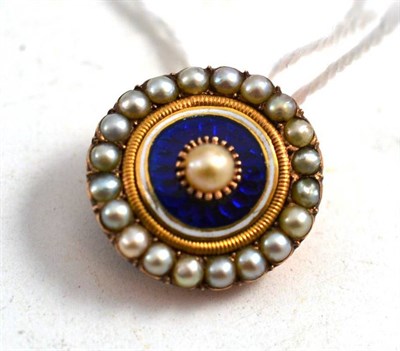 Lot 249 - A Pearl and Blue Enamelled Brooch, the shaped circular brooch with a pearl centre, a border of blue