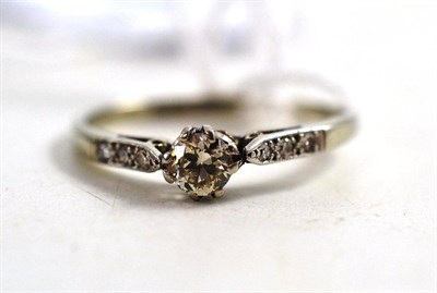 Lot 252 - A Diamond Solitaire Ring, with diamond set shoulders, principal diamond weight 0.20 carat...