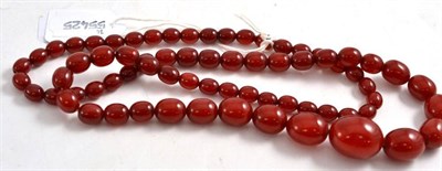 Lot 258 - A Cherry Amber Necklace, seventy graduated oval beads, length 78cm approximately