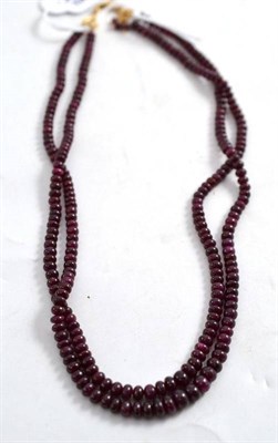 Lot 274 - A Ruby Necklace, the two strands of graduated polished ruby beads, strung to V shaped end...