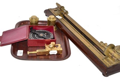 Lot 276 - A 19th Century Brass and Mahogany Yarn Tester, 54cm long; A Brass Inclinometer; A Brass Inkwell and
