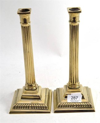 Lot 287 - A Pair of Paktong Corinthian Column Candlesticks, on square section gadrooned bases, height 27cm