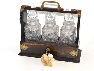 Lot 297 - A Late Victorian Coromandel Three Bottle Tantalus, with brass mounts and key, height 33cm