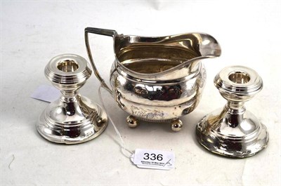 Lot 336 - A George III Silver Milk Jug; with bright cut decoration; and A Pair of Dwarf Candlesticks (3)