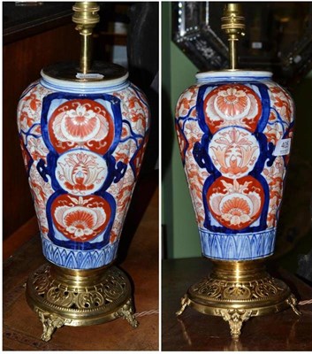 Lot 405 - A Pair of 19th Century Japanese Imari Vases, of ribbed baluster form, as table lamps on gilt...