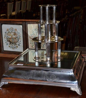 Lot 411 - A Silver Plated Cake Stand, of square form, with bevel glass plate and three tier column stands