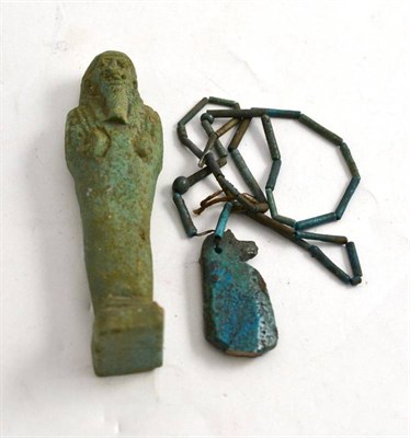 Lot 454 - An Egyptian Shabti; and An Egyptian Faience Pendant of Horos (2)