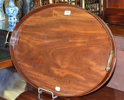 Lot 540 - A Late George III Mahogany Oval Tray, with barber's pole stringing, diameter 70cm