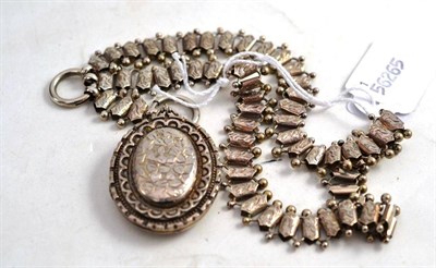 Lot 564 - A Victorian Necklace and Locket, the engraved and beaded necklace hung with a silver oval...