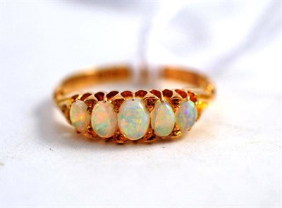 Lot 570 - An 18 Carat Gold Opal Five Stone Ring, graduated oval cabochon opals in a yellow claw setting,...