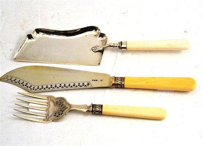 Lot 585 - A Silver Bladed Fish Slice and Fork, London 1891, with ivory handles; and A Similar Crumb Scoop (3)