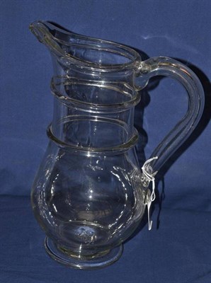 Lot 598 - A Glass Large Jug, 2nd half 18th century, of baluster form with two trailed bands to the neck...