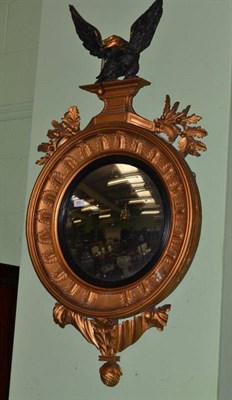 Lot 650 - A Regency Gilt Gesso Circular Wall Mirror, surmounted with an eagle, height 125cm