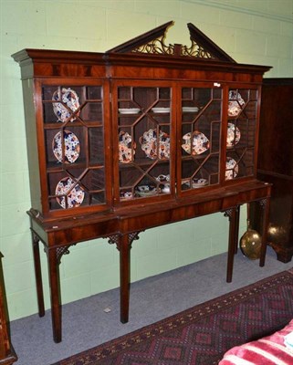 Lot 652 - A Mahogany Breakfront Display Cabinet, with astragal glazed doors, raised on associated table...