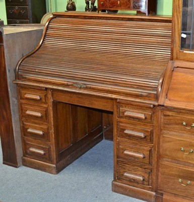 Lot 681 - An Early 20th Century Oak Roll Top Desk, fitted with eight drawers, 126cm wide