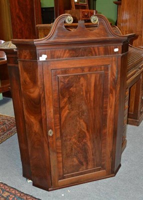 Lot 683 - A George III Mahogany Straight Front Hanging Corner Cupboard, with swan neck pediment, 89cm wide