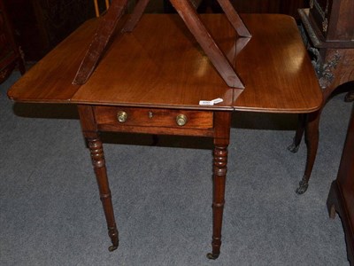 Lot 690 - A Regency Mahogany Pembroke Table, on turned legs and castors, height 72cm