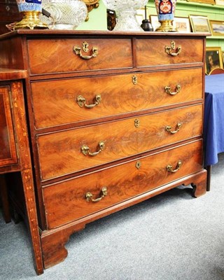 Lot 725 - A George III Mahogany Straight Front Five Drawer Chest, fitted with brass rococo handles, raised on