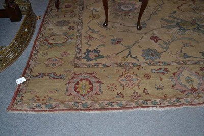 Lot 759 - Ziegler Design Carpet The cream field of large palmettes and scrolling vines enclosed by...