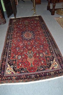 Lot 775 - Bidjar Rug Persian Kurdistan The claret field with two urns issuing flowers centred by an...