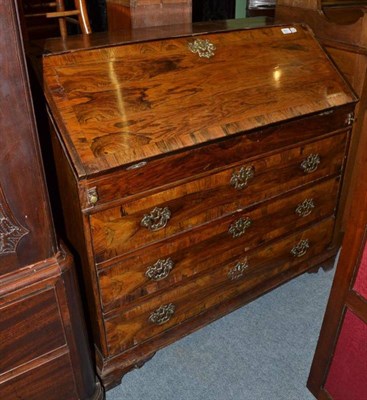 Lot 811 - A Rosewood Veneered and Crossbanded Bureau, in George III style, the fall enclosing a fitted...