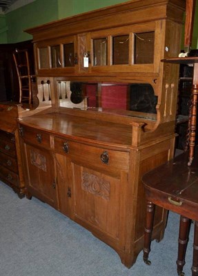 Lot 812 - An Arts & Crafts Carved Oak Sideboard, the superstructure with moulded cornice over two glazed...