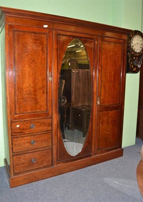 Lot 819 - An Edwardian Inlaid Mahogany Triple Door Wardrobe, fitted with three drawers, 195cm wide