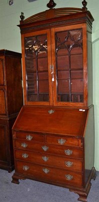 Lot 821 - A George III Mahogany Bureau Bookcase, late 18th century, the domed pediment surmounted by...