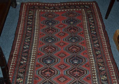 Lot 850 - Karabagh Rug South Caucasus The soft madder field with two columns of linked diamond medallions...