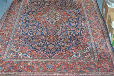 Lot 853 - Kashan Rug Central Persia The deep indigo field of floral vines and palmettes around a cusped...