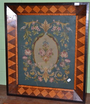 Lot 1044 - A 19th Century Woolwork Panel, with roses in an oval, 50cm by 61cm, in a parquetry frame