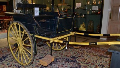 Lot 1215 - A Horse Cart painted black and yellow with adjustable double seat, the wheels stamped H Smith,...