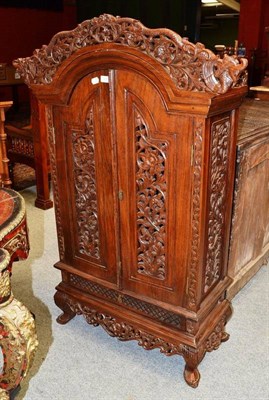 Lot 1226 - A Chinese Style Hardwood Cabinet, with dome top and foliate carved grill doors, 72cm wide