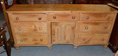 Lot 1233 - A 19th Century Pine Dresser, with seven drawers and a central cupboard, 210cm wide