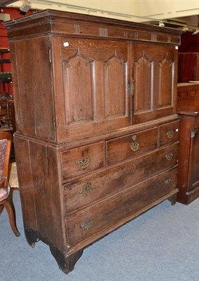 Lot 1237 - An 18th Century Oak Housekeeper's Cupboard, with fielded panel cupboard door and drawers below,...