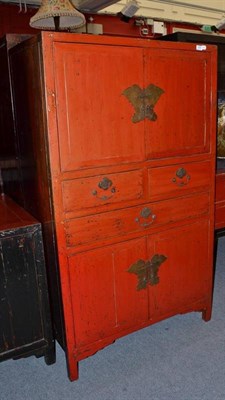 Lot 1250 - A Chinese Red Lacquer Cabinet, 20th century, with two cupboard doors over three drawers and...